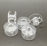 25 Clear bobbins in a box