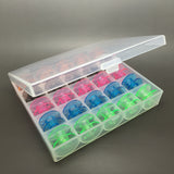 25 coloured bobbins in a box