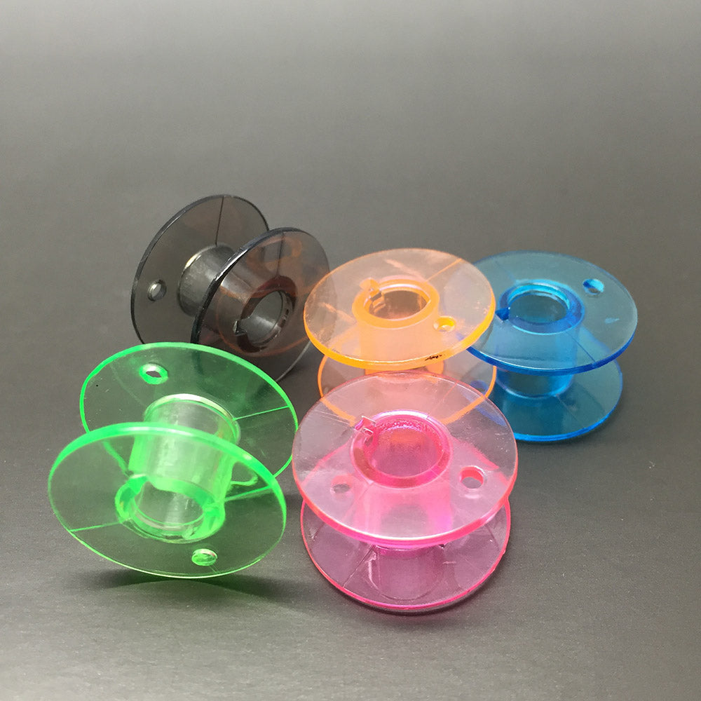 25 coloured bobbins in a box