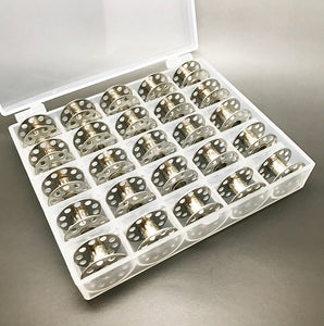 25 Metal bobbins in a box